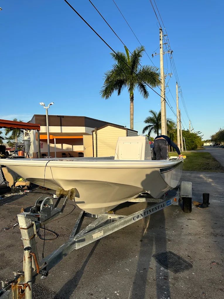 Center console boat on trailer being hand detailed
