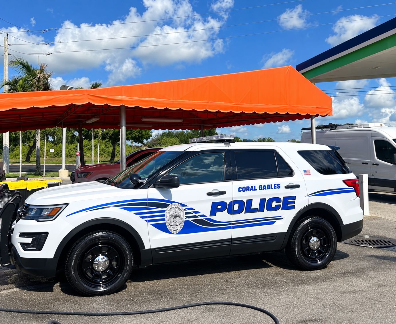 Police SUV freshly hand washed under the Car Wash Aguilon canopy